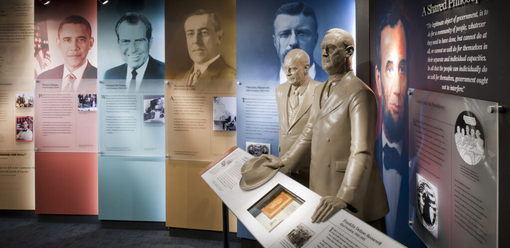 Photos of Presidents Barack Obama, Richard M. Nixon, Woodrow Wilson and Theodore Roosevelt flank statues of Dwight D. Eisenhower and Franklin Delano Roosevelt.