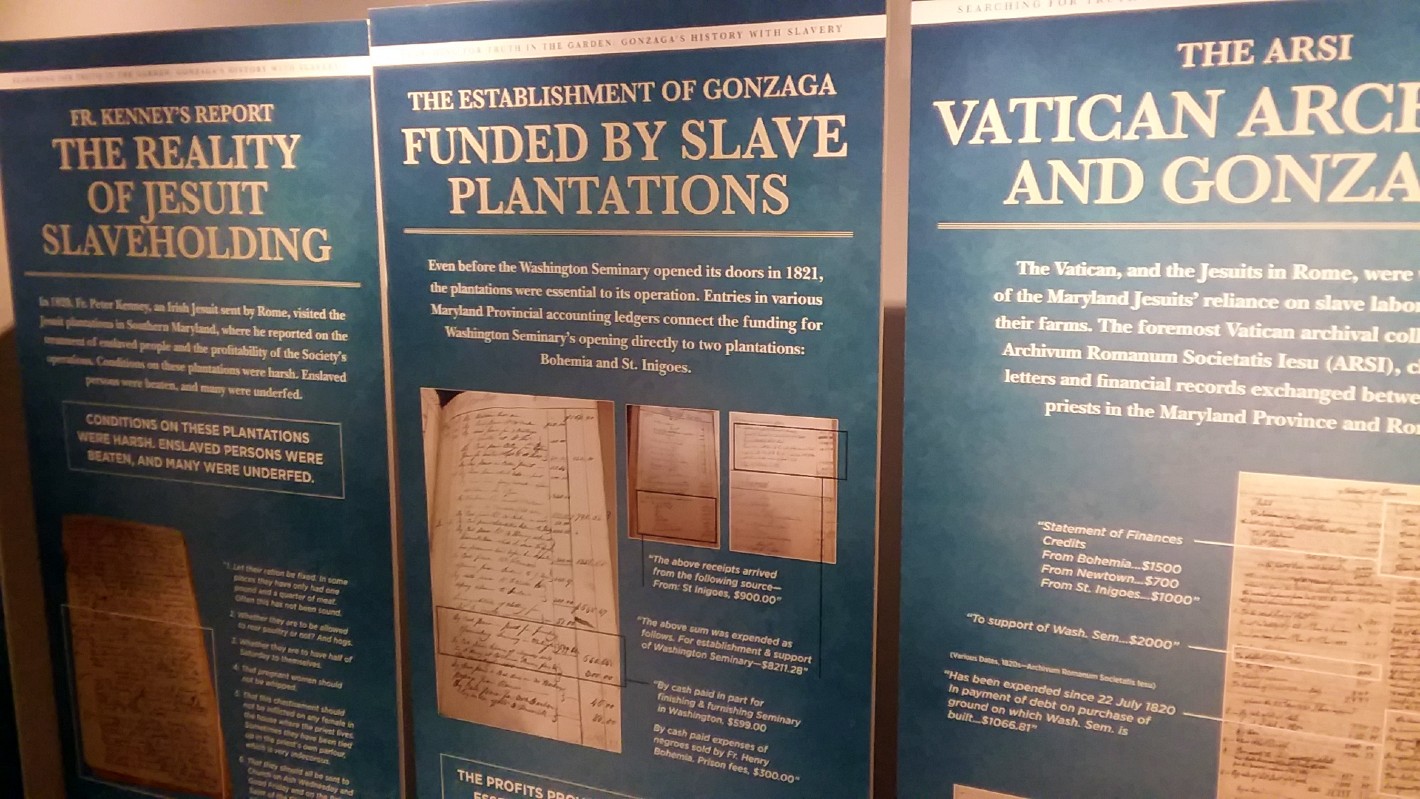 Blue presentation panels line the walls of the Center for Education and Leadership. On the panels is information researched by Gonzaga College High School about their institution's connections to slavery. 