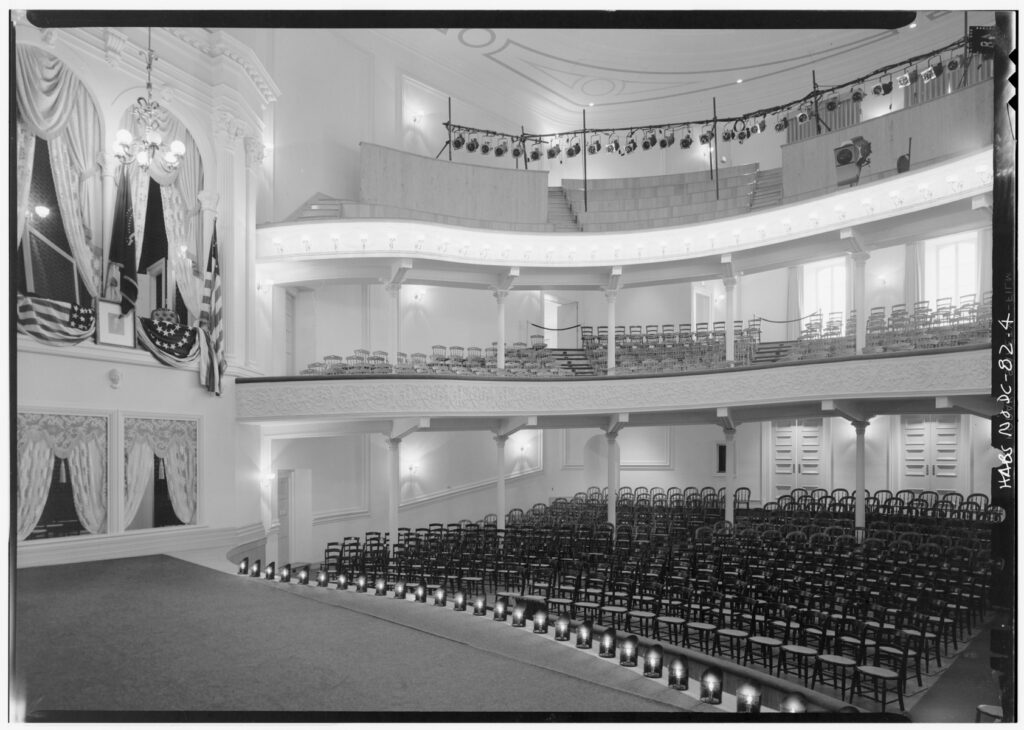 Black and white photograph of the Ford's Theatre stage and seating.