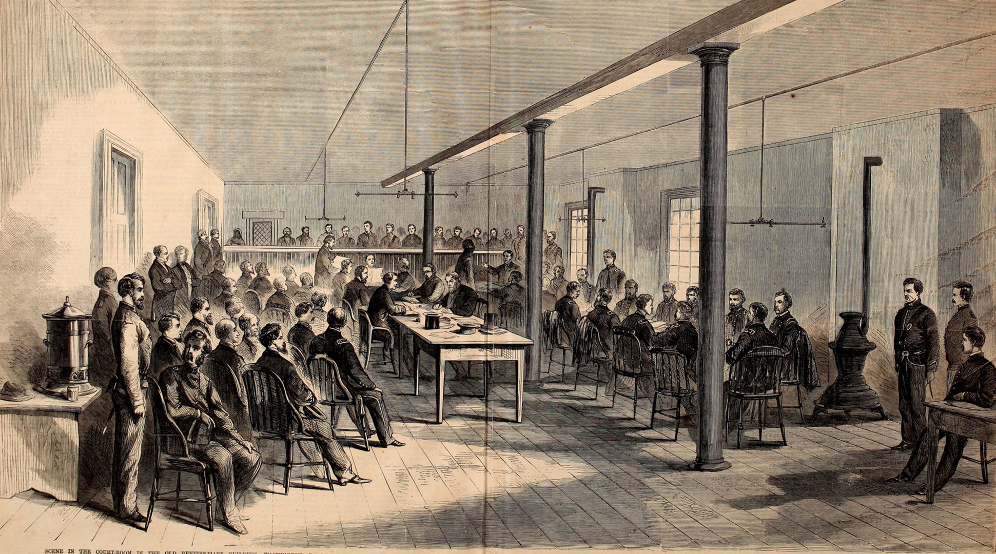 Illustration of more than 30 men gathered around tables and dozens more standing in a nearby gallery during the military tribunal for those accused of conspiracy in the Lincoln assassination.