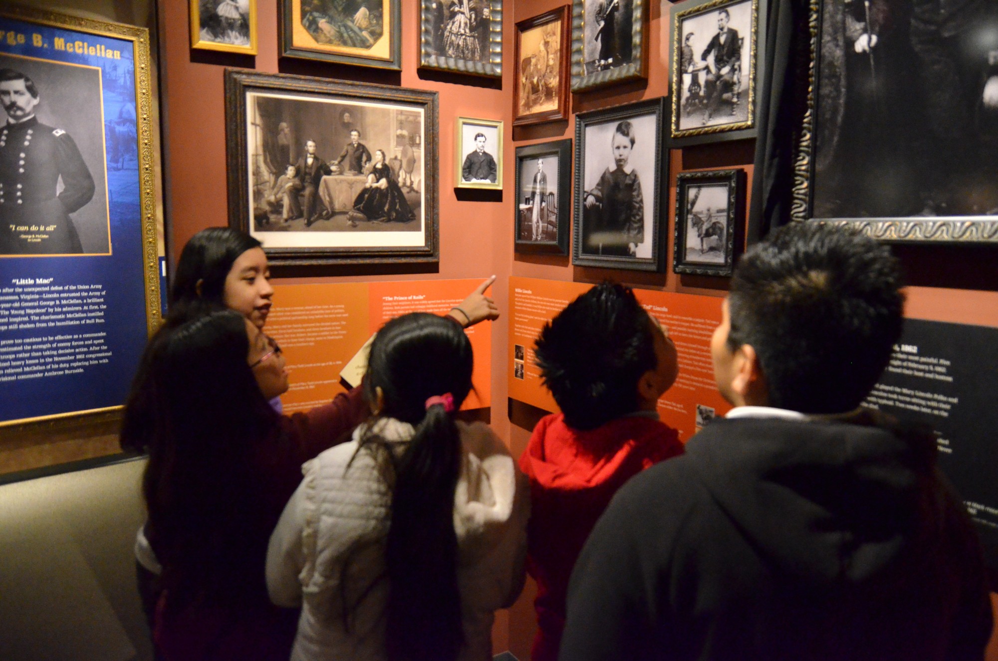 A group of elementary-school aged students explore historic photographs of the Lincoln family children at the Ford's Theatre Museum.