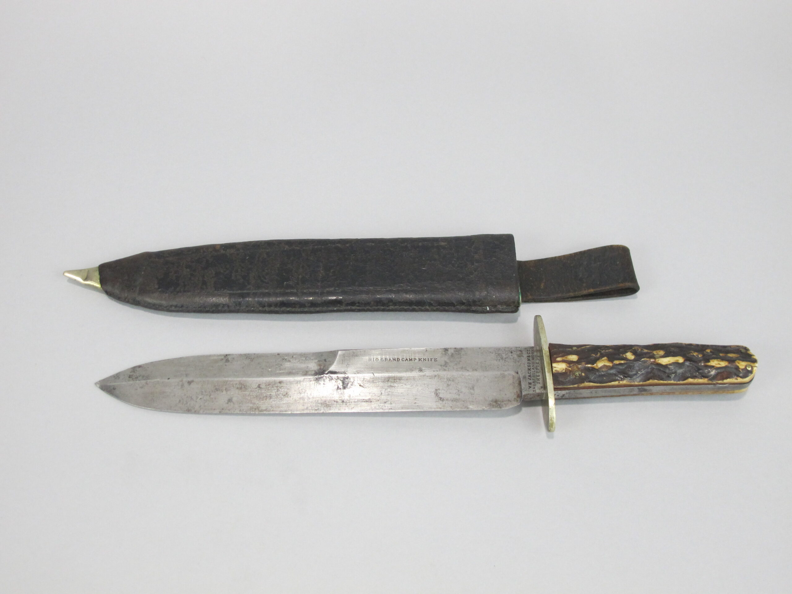 Photograph of an old knife and its sheath.