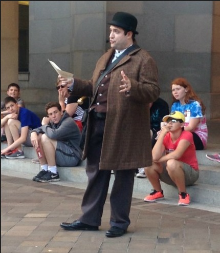 Actor Matthew Dewberry, dressed as Detective McDevitt, leads a walking tour.