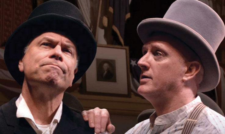Actors playing Harry Ford and Harry Hawk, in 1860s costume and both wearing top hats, speak to one another.
