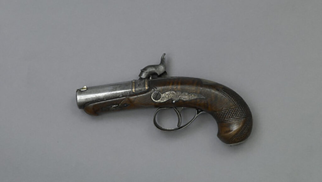 A small handheld derringer on a grey background.