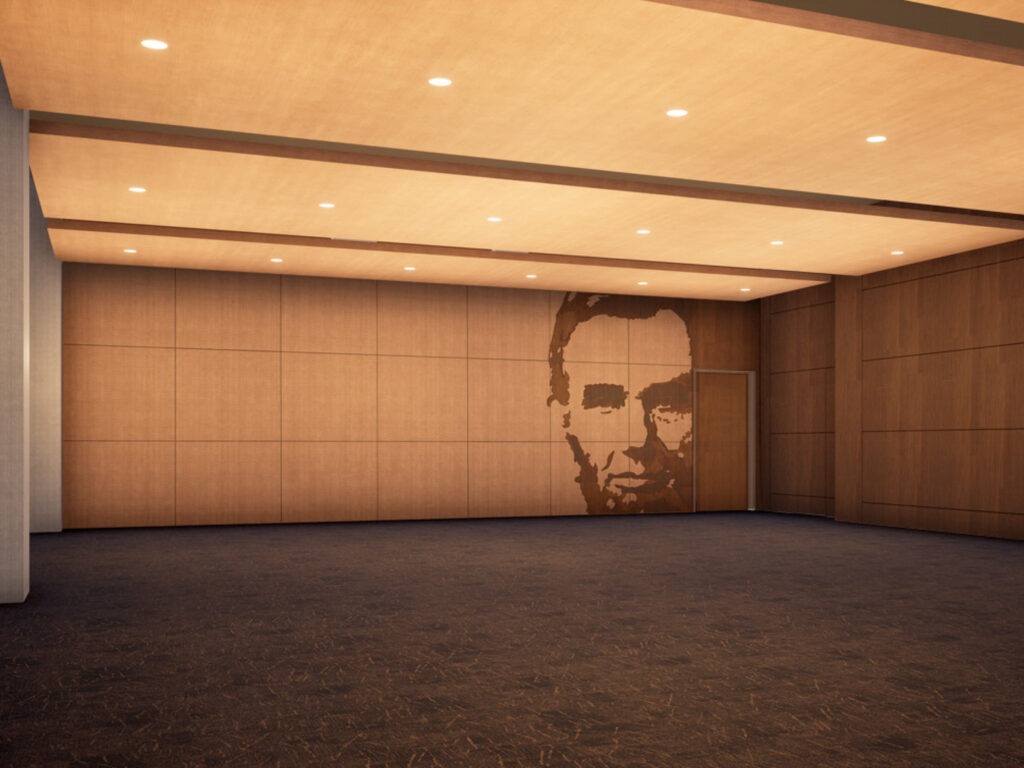 Rendering of the future flexible event space for larger on-site dinners, receptions and expanded public programming. Large empty room with recessed overhead lighting, carpeted floors and a wall featuring a floor to ceiling Abraham Lincoln portrait.