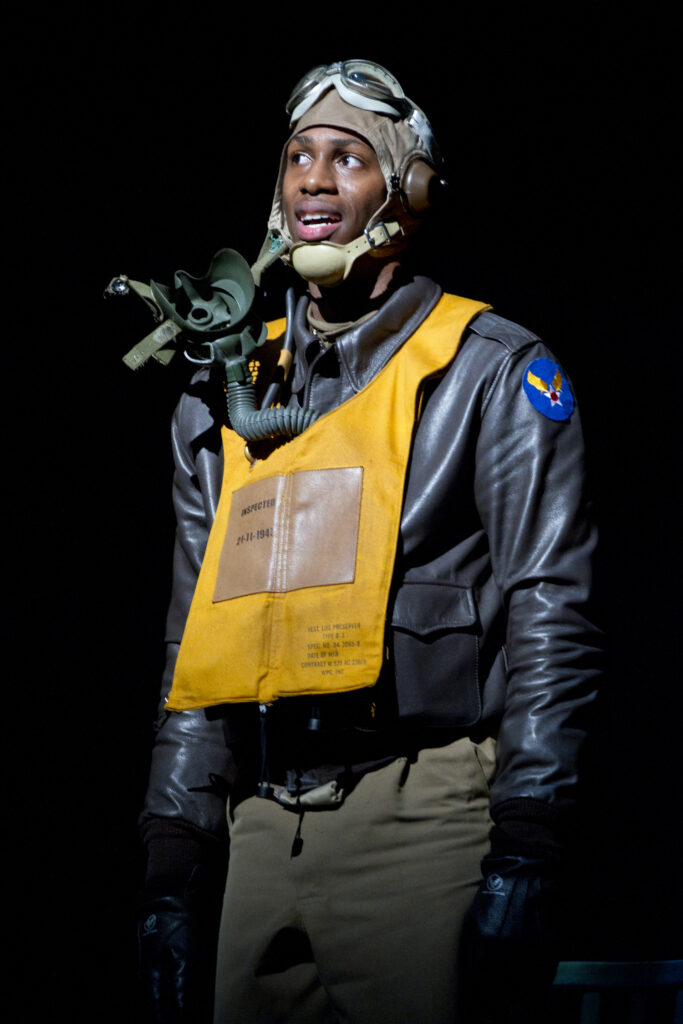 Photograph of an African-American man in a flight suit and a flight helmet.