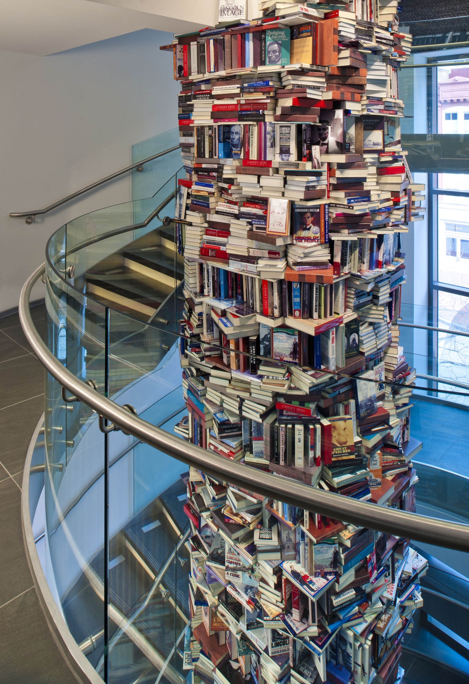 Replicas of books are stacked two stories high.