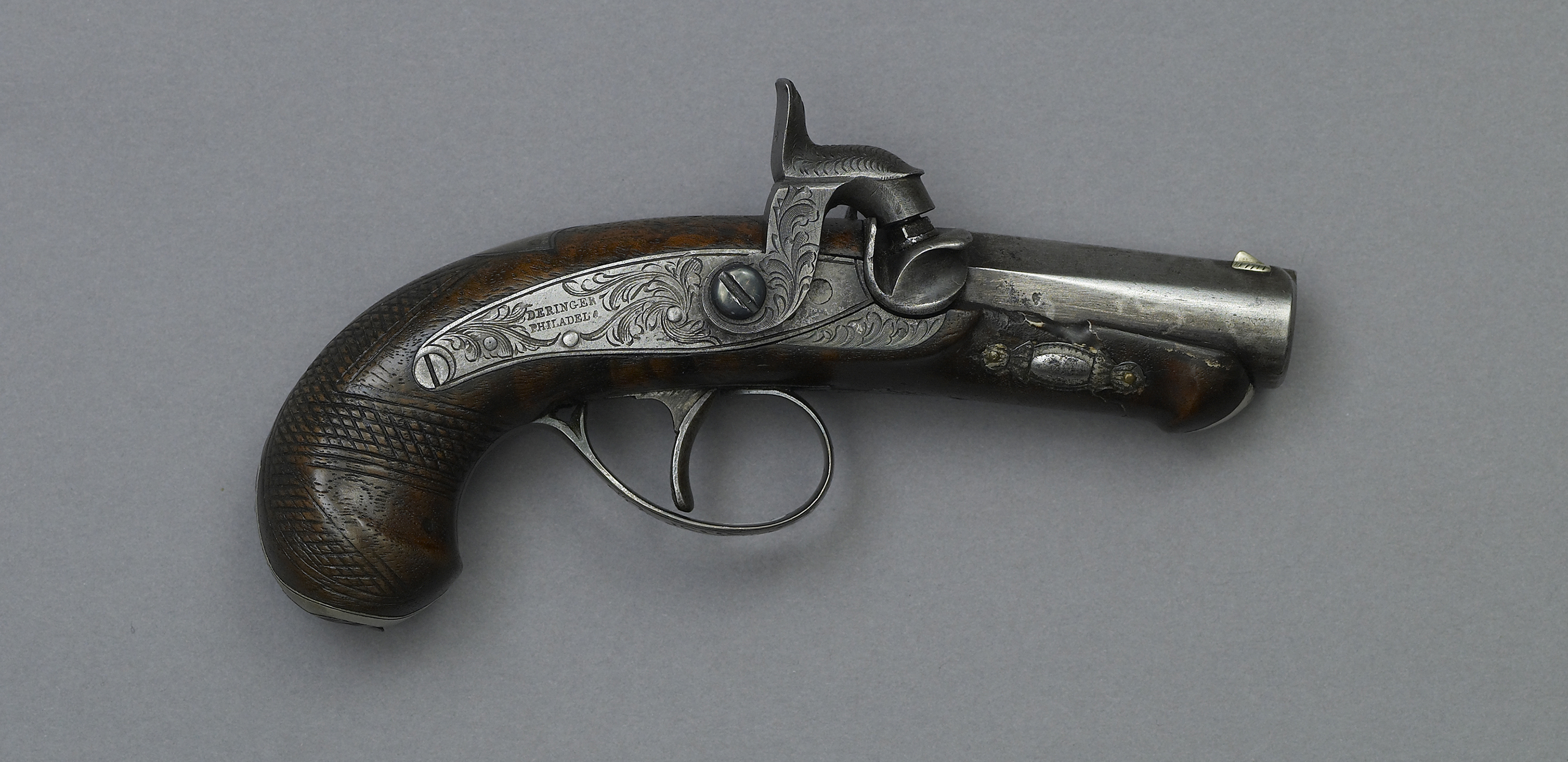 Close up photograph of a small derringer pistol