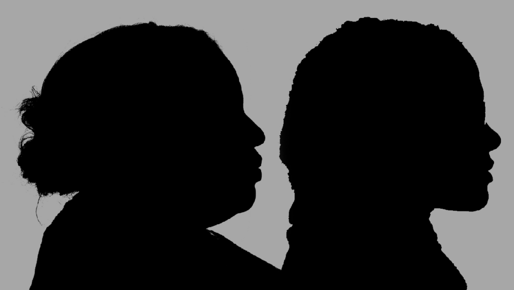 A silhouette of two African-American women in profile.