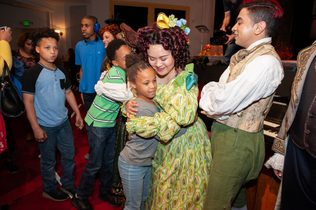 Several children embrace and talk with actors from “Into the Woods” inside of Ford’s Theatre.