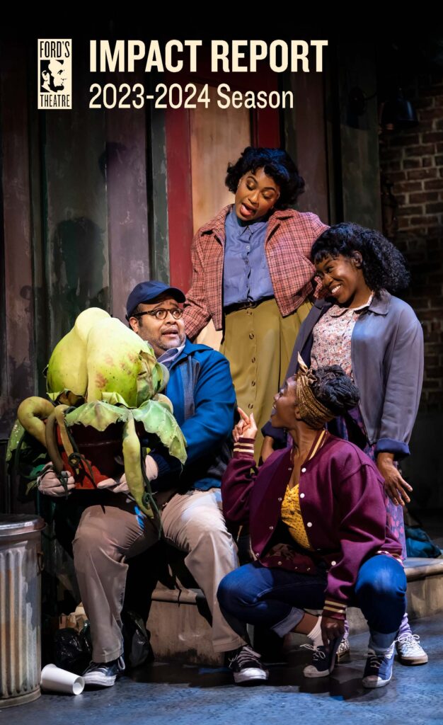 Four actors on a stage all looking at large venus-fly trap. 