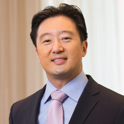 Photograph of an Asian man in a suit.