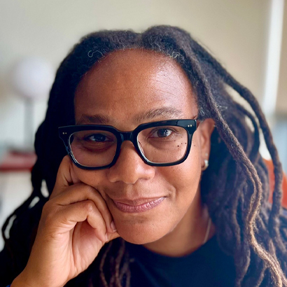 Headshot of a Black woman wearing glasses.