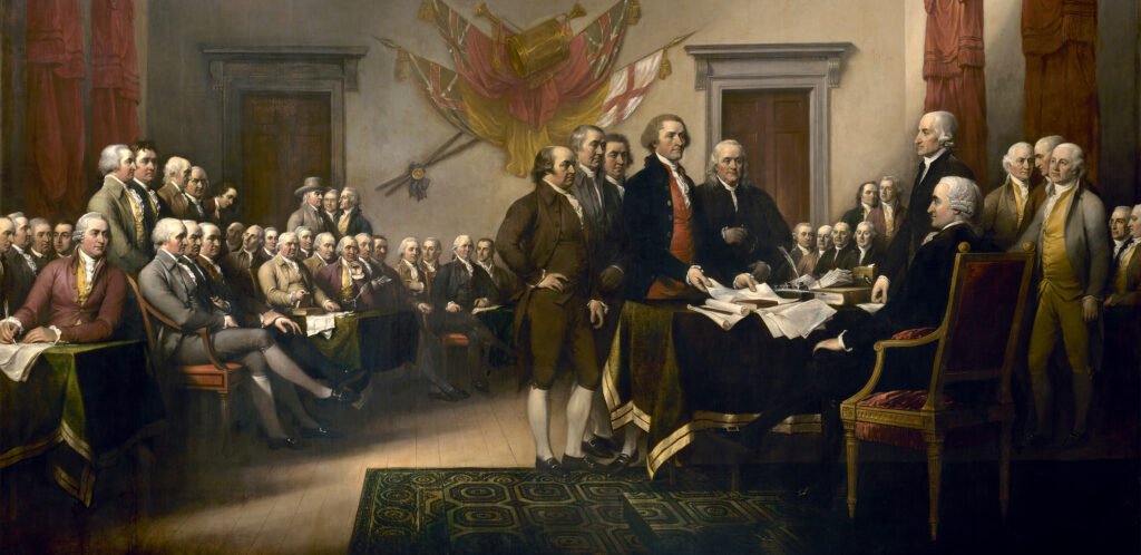 Painting of a large group of men dressed in 18th century clothing gathered in a meeting hall. Five men in the center present documents to a man seated behind a desk.