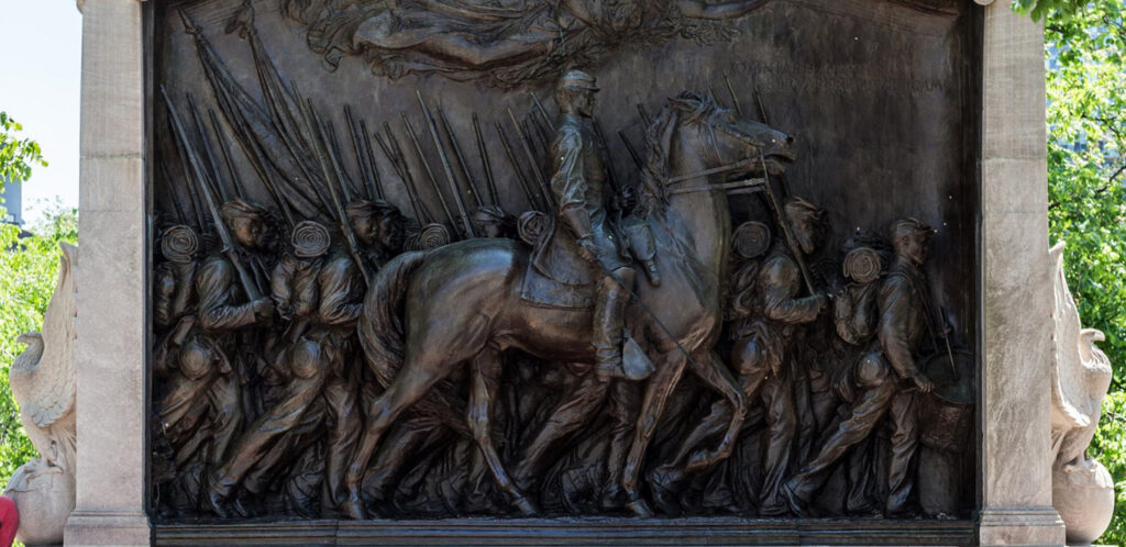 A bronze relief of a regiment of civil war soldiers, with the foreground dominated by an officer on horseback.